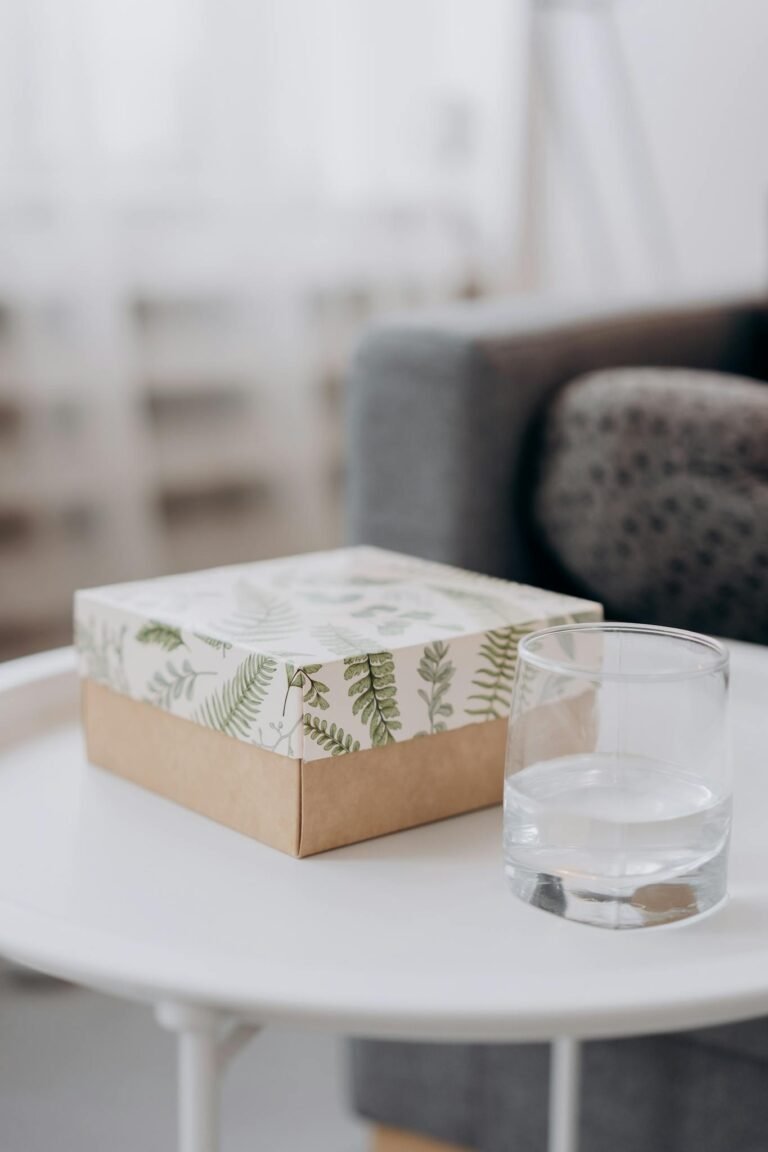 Box Of Essential Oils And Glass Of Water On Table